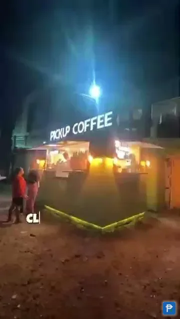 A Pickup Coffee stand lit up at night, one of the merchants Novaluxia PH points vouchers redeem at