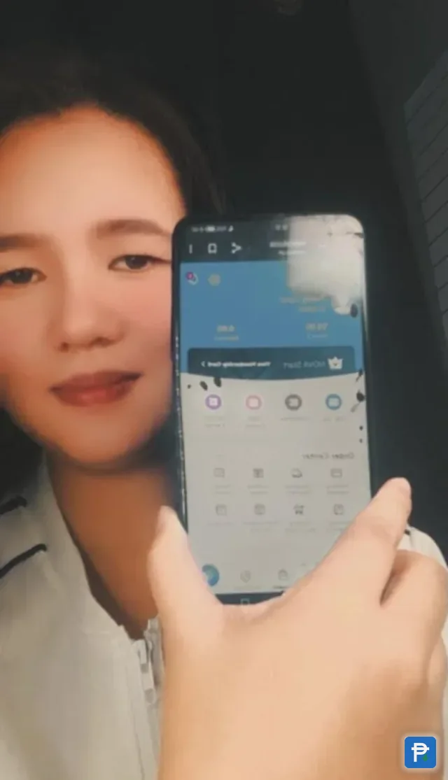 A woman in a car holding a phone showing the Novaluxia account screen