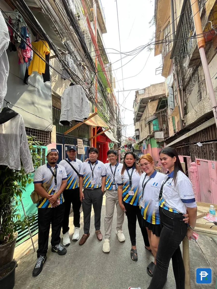 Uniformed field teams walking a narrow residential street